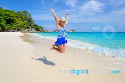 Girl Jumping With Happy On The Beach At Thailand Stock Photo