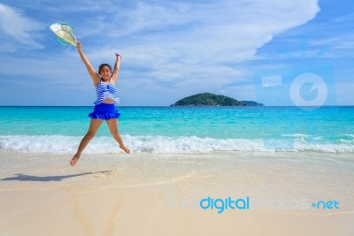 Girl Jumping With Happy On The Beach At Thailand Stock Photo