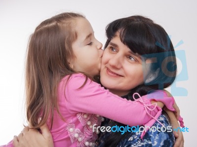 Girl Kissing Her Mother Stock Photo