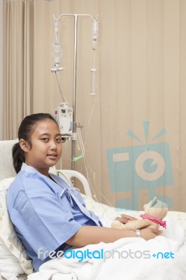 Girl Lying On Patient Bed On Hospital Treatment Room Waiting For… Stock Photo