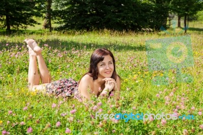 Girl Lying On The Grass In The Park Stock Photo