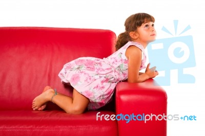 Girl On Red Sofa Stock Photo