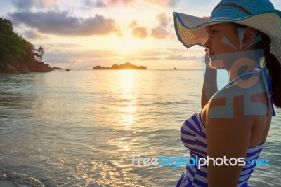 Girl On The Beach At Sunrise Stock Photo