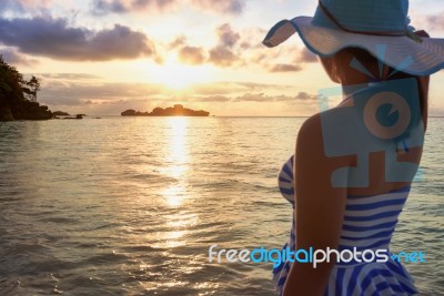 Girl On The Beach At Sunrise Stock Photo