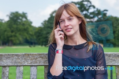 Girl Phoning With Mobile Phone In Nature Stock Photo