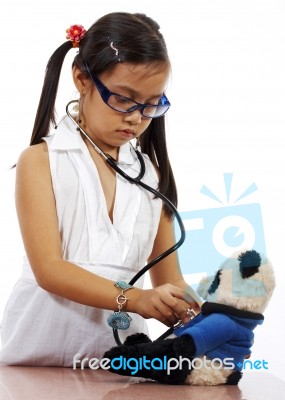 Girl Playing At Being A Doctor Stock Photo