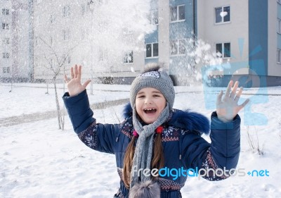 Girl Playing In The Snow Stock Photo