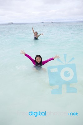 Girl Playing On Sea Beach With Happy Face Stock Photo