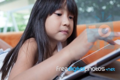 Girl Playing With Tablet Stock Photo