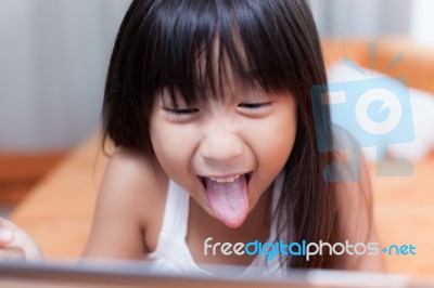 Girl Playing With Tablet Stock Photo