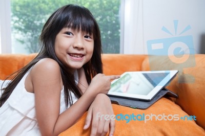 Girl Playing With Tablet Stock Photo