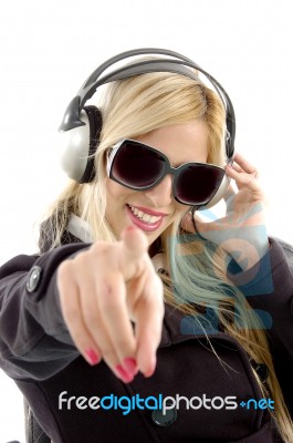 Girl Pointing forward With Earphone Stock Photo