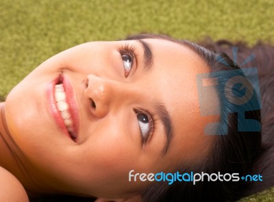 Girl Relaxing On Grass Stock Photo