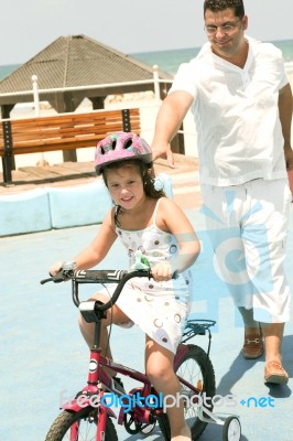 Girl Riding Bicycle Stock Photo