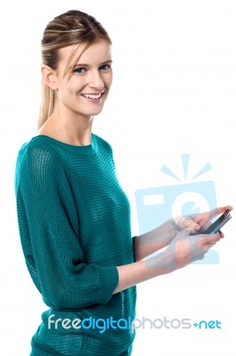 Girl Sending Text Message Through Cellphone Stock Photo