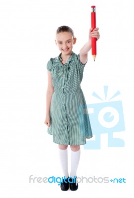 Girl Showing Big Red Pencil Stock Photo