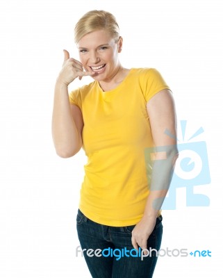 Girl Showing Calling Gesture Stock Photo