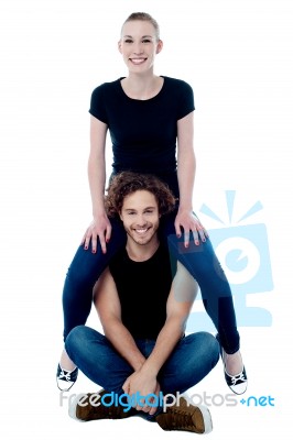 Girl Sitting On Boyfriend's Shoulders Stock Photo