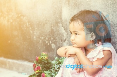 Girl Sitting On The Side Walls Stock Photo