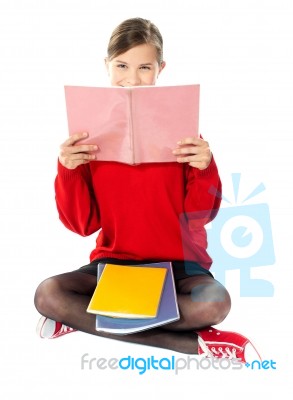 Girl Sitting With Books On Her Lap Stock Photo