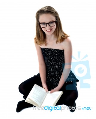 Girl Sitting With Opened Book Stock Photo