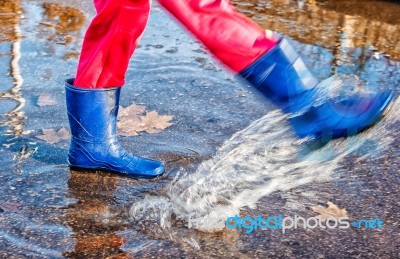 Girl Standing In A Puddle Of Water Splashes Stock Photo