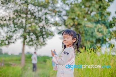 Girl Standing In The Field Of Rubber Happy Stock Photo