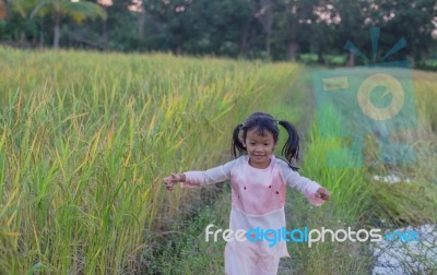 Girl Standing In The Field Of Rubber Happy Stock Photo