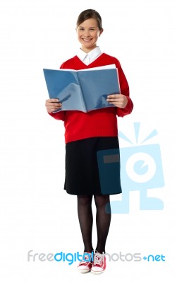 Girl Standing With Exercise Book Stock Photo