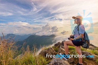 Girl Tourist On Mountains At Sunset Stock Photo