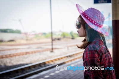 Girl Tourist Sitting On A Bench In A Train Station Stock Photo