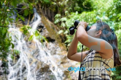 Girl Using Binoculars In Forest Stock Photo