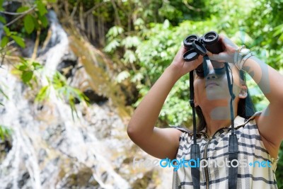 Girl Using Binoculars In Forest Stock Photo