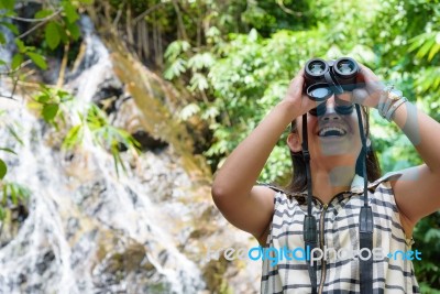 Girl Using Binoculars In Forest Stock Photo