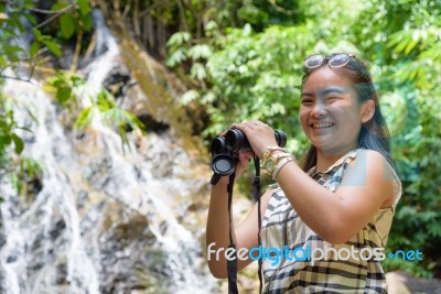 Girl Using Binoculars In Forest Stock Photo