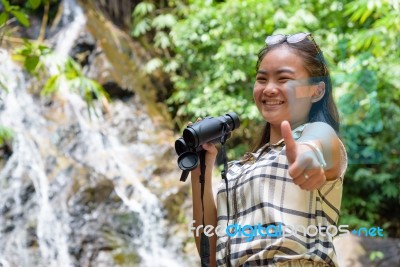 Girl Using Binoculars In Forest Stock Photo