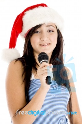 Girl Wearing Christmas Hat Holding Microphone Stock Photo