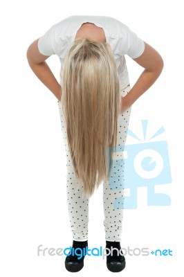 Girl With Long Hair Bending Down Stock Photo