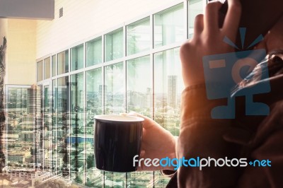 Girl With Of Coffee And Talking On The Phone Stock Photo