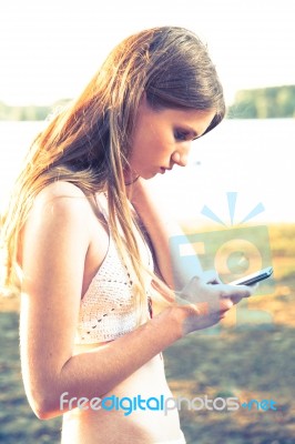 Girl With Smart Phone Near Beach Stock Photo