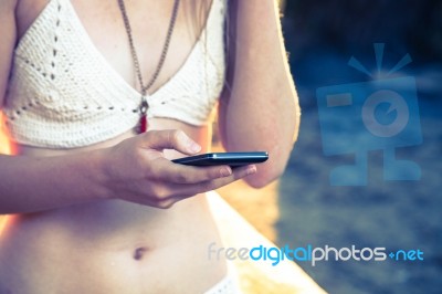 Girl With Smart Phone Near Beach Stock Photo