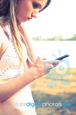 Girl With Smart Phone Near Beach Stock Photo