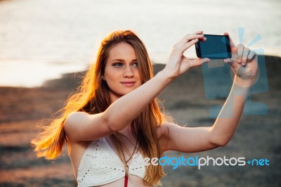 Girl With Smart Phone Near Beach Stock Photo