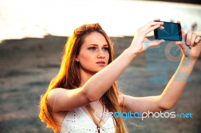 Girl With Smart Phone Near Beach Stock Photo