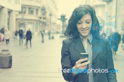 Girl With Smartphone Walking On City Stock Photo