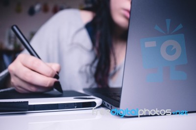 Girl Writing On A Tablet Stock Photo