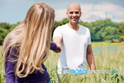 Girlfriend Pulling Her Boyfriend In Love Stock Photo