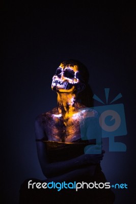 Girl's Face Painted Uv Skull Stock Photo