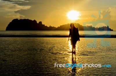 Girls On The Beach During Sunrise Stock Photo