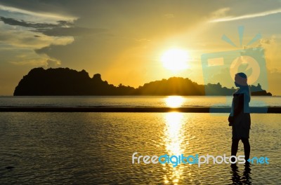 Girls On The Beach During Sunrise Stock Photo